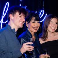 Philly smiles with two grads on stage doing a cheers